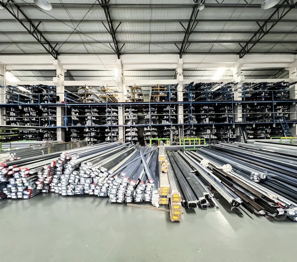 Industrial raw material warehouse storing large volumes of bundled aluminum extrusion profiles on metal racks